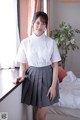 A woman in a school uniform posing for a picture.